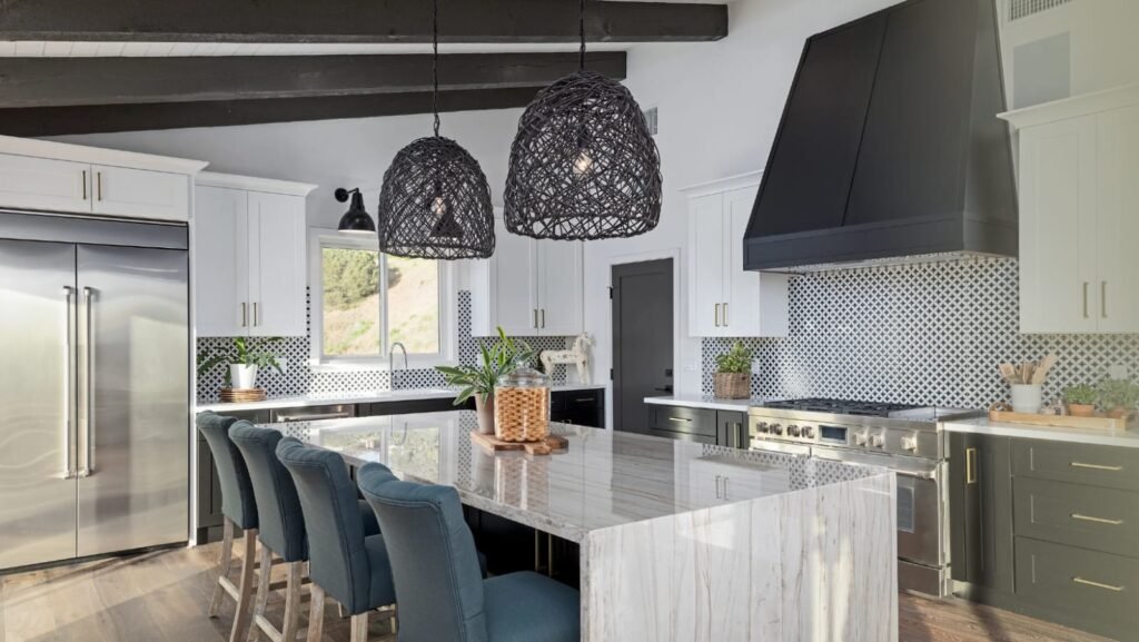 Cozy kitchen with open shelving, potted herbs, and warm pendant lighting on a budget